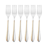 Six elegant dinner forks featuring decorative gold pattern handles arranged in parallel formation